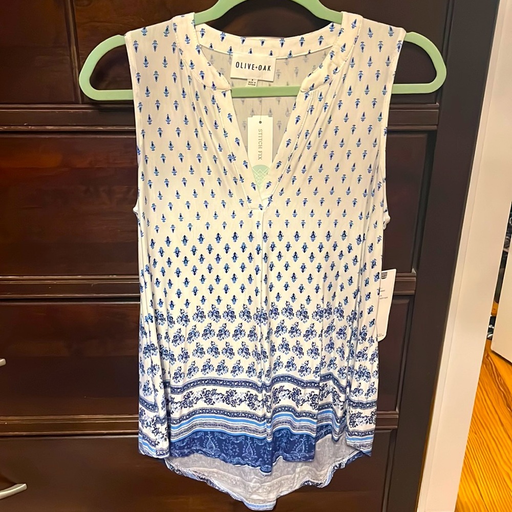 Sleeveless tunic. High low design. New with tags. Size S
